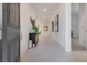 Bright, neutral hallway featuring tile floors, modern art and decor at 827 Klamath Springs St, Henderson, NV 89011