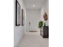 Bright, neutral hallway featuring tile floors, modern art and decor at 827 Klamath Springs St, Henderson, NV 89011