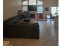 Spacious living room featuring tile floors, a fireplace, and large windows for natural light at 8277 Orange Vale Ave, Las Vegas, NV 89131