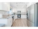 Open kitchen with stainless steel appliances, granite countertops, and bright lighting at 8812 Marble Dr, Las Vegas, NV 89134
