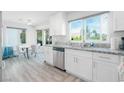 Bright kitchen area with stainless steel dishwasher and hardwood floors at 8812 Marble Dr, Las Vegas, NV 89134