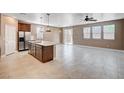 Spacious kitchen and living room area features stainless steel appliances and tile floors at 9217 Valley Betica Ave, Las Vegas, NV 89148