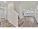 Bright foyer with hardwood flooring, staircase, and view of open floor plan and natural light at 9327 Ettrick Ct, Las Vegas, NV 89178