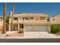 Inviting two-story home featuring a three-car garage, a balcony, and well-maintained landscaping at 9604 Summer Cypress St, Las Vegas, NV 89123