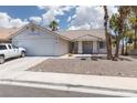 Charming single-story home with desert landscaping, tiled roof, and a two-car garage at 998 Hunters Run Dr, Henderson, NV 89002
