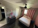 Comfortable bedroom features wood floor, modern ceiling fan, and ample natural light at , Las Vegas, NV 89104