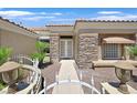 A welcoming front entrance with stone accents, double doors, and decorative iron gate at 10700 Button Willow Dr, Las Vegas, NV 89134