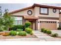 Charming two-story home showcasing a well-maintained lawn and an attached garage at 2705 Chokecherry Ave, Henderson, NV 89074