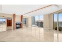 Open living area with a modern fireplace and expansive city views at 2747 Paradise Rd # 2704, Las Vegas, NV 89109