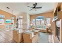 Airy living space with a fireplace, stylish furnishings, and sliding glass doors to the backyard at 2889 Anteres St, Las Vegas, NV 89117