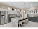 Bright kitchen featuring modern appliances, a central island with bar stool seating, and updated cabinetry at 3120 Darby Falls Dr, Las Vegas, NV 89134