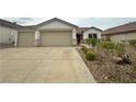 Inviting single-story home with a two-car garage, concrete driveway and xeriscaped front yard at 33 Hatten Bay St, Henderson, NV 89012