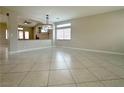Spacious living area featuring tile floors, neutral walls and a modern light fixture at 33 Hatten Bay St, Henderson, NV 89012