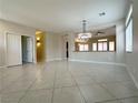 Open-concept living area featuring tile floors, neutral walls and a pass-through to the kitchen at 33 Hatten Bay St, Henderson, NV 89012