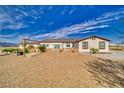 Cozy backyard featuring a dining area, garden area with planters and drought resistant landscaping at 3301 Underbrush Ave, Pahrump, NV 89048