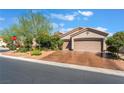 Front exterior view of the single-story home featuring desert landscaping and a two-car garage at 4014 Trapani Pl, Las Vegas, NV 89141