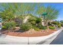 Manicured front yard of this well-maintained single-story home featuring desert landscaping and mature trees at 4014 Trapani Pl, Las Vegas, NV 89141