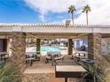 Outdoor kitchen and dining area with grill, tables, and seating, perfect for community gatherings at 5420 Centurion Ct # 104, Las Vegas, NV 89122
