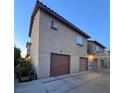 Two-story townhouse with individual one-car garages and convenient driveway access at 558 Roxella Ln # D, Las Vegas, NV 89110