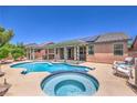Relaxing backyard pool with an integrated spa and a covered patio, great for outdoor living at 5889 Wildhorse Ledge Ave, Las Vegas, NV 89131