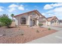 Landscaped single-story home featuring desert landscaping, tile roof, and two-car garage at 632 Hitchen Post Dr, Henderson, NV 89011