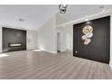Modern living room with new flooring, fireplace, and accent walls at 632 Hitchen Post Dr, Henderson, NV 89011