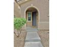 Close-up of front porch, showing arched entryway and stone landscape at 7513 Brisa Del Mar Ave, Las Vegas, NV 89179