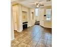 Open living room with tile flooring, ceiling fan and staircase at 7513 Brisa Del Mar Ave, Las Vegas, NV 89179