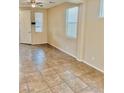 Spacious living room featuring tile floors and natural light from windows at 7513 Brisa Del Mar Ave, Las Vegas, NV 89179