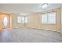Bright living room with neutral paint, plank floors, and ample natural light at 7929 Palace Monaco Ave, Las Vegas, NV 89117