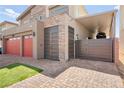 Stylish home with a brick driveway, two-car garage and gated access at 8955 Ruby Moon Dr, Las Vegas, NV 89139