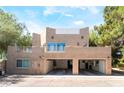 Unique exterior featuring a spacious three-car garage and rooftop deck for outdoor enjoyment at 10445 Schirlls St, Las Vegas, NV 89141