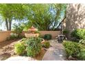 Beautifully landscaped front yard with a charming water fountain, enhancing curb appeal at 10445 Schirlls St, Las Vegas, NV 89141