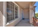 Covered front porch featuring security door and shade, with an inviting entrance and enhanced curb appeal at 1048 Menands Ave, Las Vegas, NV 89123