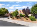 Inviting single-story home with desert landscaping, mature trees and a well-manicured lawn at 12276 Caminita Pl, Las Vegas, NV 89138