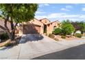 Charming single-story home showcasing desert landscaping, mature trees and a spacious three-car garage at 12276 Caminita Pl, Las Vegas, NV 89138