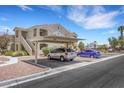 Exterior view of condo building with covered parking and tidy landscaping at 1881 W Alexander Rd # 2093, North Las Vegas, NV 89032