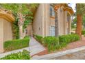 Inviting townhome exterior with manicured hedges and desert-friendly landscaping at 2050 W Warm Springs Rd # 4021, Henderson, NV 89014
