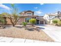 Two-story home featuring low-maintenance desert landscaping at 2625 Cattrack Ave, North Las Vegas, NV 89081