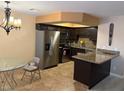 Modern kitchen features stainless steel appliances, granite counters, and tile floors at 2701 Beaver Creek Ct # 201, Las Vegas, NV 89117