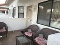 Cozy patio with three cushioned wicker chairs, glass table and outdoor seating area at 2701 Beaver Creek Ct # 201, Las Vegas, NV 89117