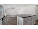 Open-concept living area featuring a kitchen island with gray countertops at 4216 Golden Sol St, North Las Vegas, NV 89032