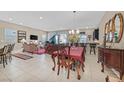 Spacious living room with tile floors, a dining area, and modern lighting fixtures at 444 Middlestone Ave, Henderson, NV 89011