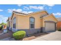 Charming single-story home featuring a tile roof, neutral stucco, and a two-car garage at 5031 Droubay Dr, Las Vegas, NV 89122