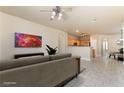 Comfortable living room showcasing tile floors, and an open floor plan leading to the kitchen at 5031 Droubay Dr, Las Vegas, NV 89122
