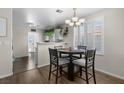 Cozy dining area with modern chandelier and ample natural light from the window at 5550 Ramirez St, North Las Vegas, NV 89031