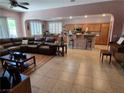 Spacious living room open to the kitchen, featuring tile flooring and comfortable seating at 6009 Arbor Crest St, North Las Vegas, NV 89081
