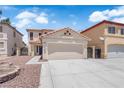 Attractive two-story stucco home with landscaped front yard and two-car garage at 638 Ribbon Grass Ave, Las Vegas, NV 89183