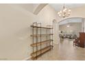 Bright entryway featuring tile floors, high ceilings, archways, and modern shelving at 6413 White Tiger Ct, Las Vegas, NV 89130