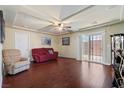Spacious living room with hardwood floors and sliding glass door access to the yard at 6705 Philharmonic Ave, Las Vegas, NV 89139